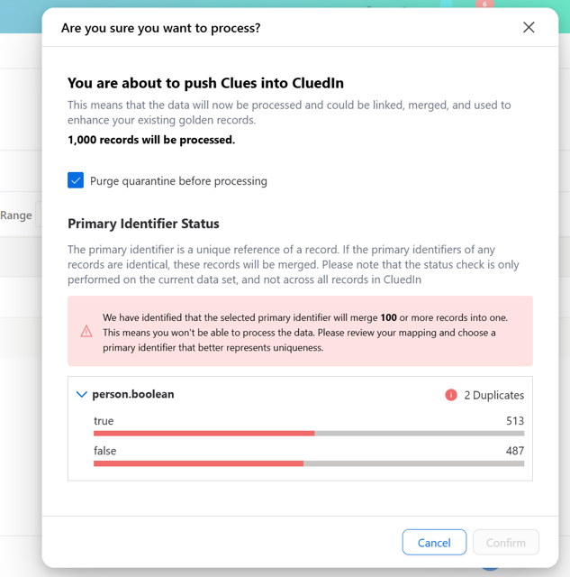 Processing confirmation dialog warning that the selected primary identifier would merge 100 or more records, with the Confirm button disabled